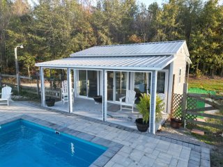 Exterior View of a Metal Pool House in Summer
